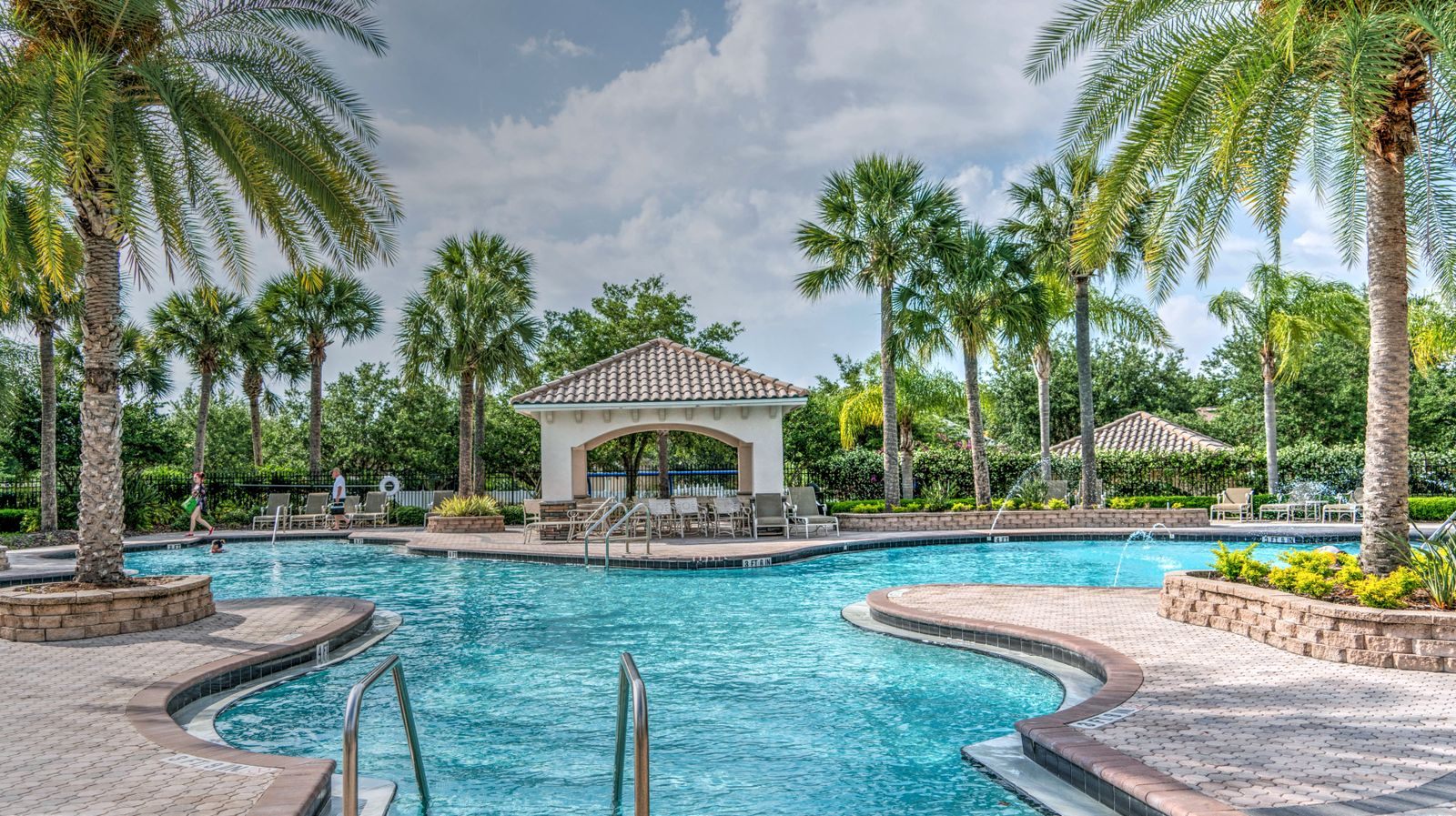 Resort pool with a gazebo and palm trees. Are travel clubs worth it? Price a stay like this inside and outside the club